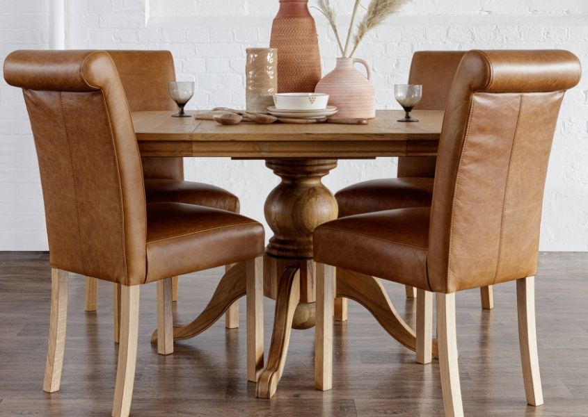 round dining table with brown leather dining chairs