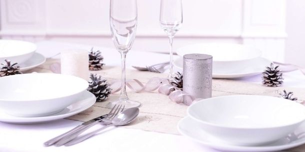 Bright white Christmas dining table with white plates