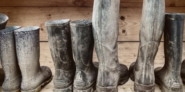 Line of muddy wellie boots