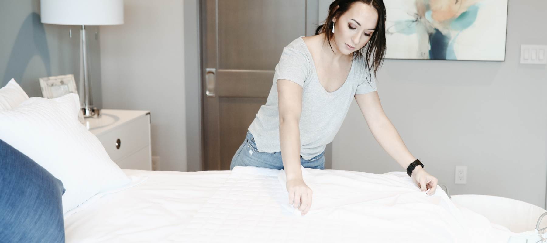 Women in t-shirt making the bed