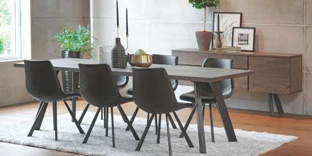 Industrial oak dinging table with dark grey leather dining chairs and industrial sideboard