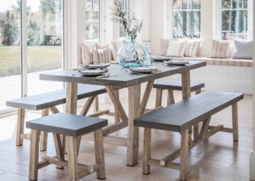 Wooden dining table in pale wood with matching dining bench and stool