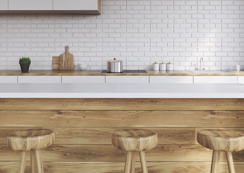 Wooden kitchen island with three wooden bar stools