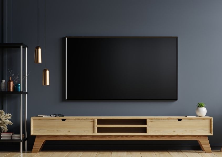 dark painted living room with large tv screen on wall