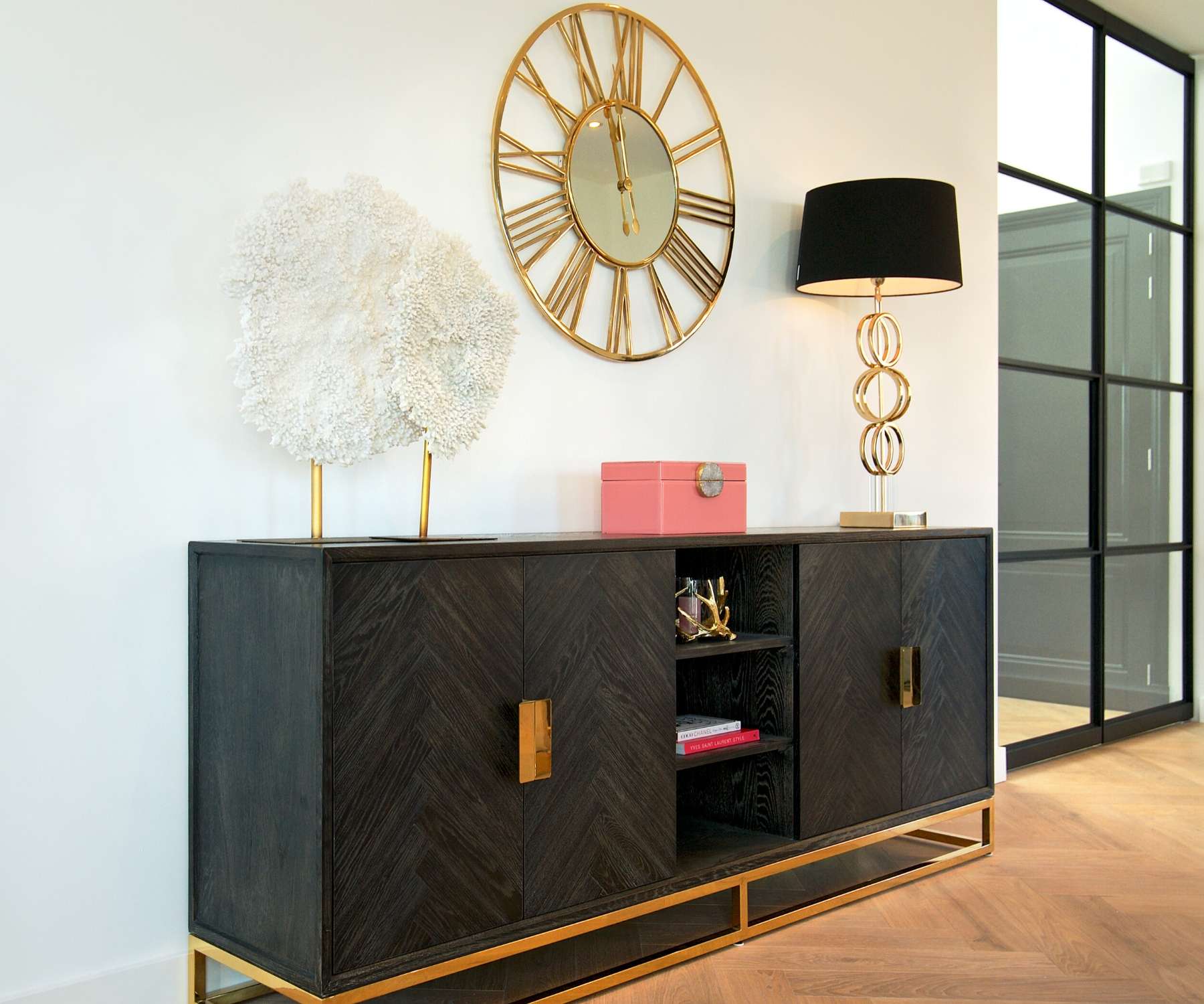 dark wood industrial sideboard with gold accessories