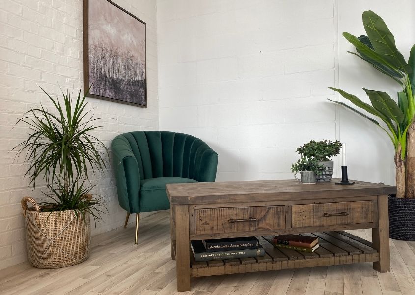 Reclaimed wood coffee table with green velvet armchair