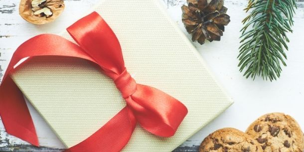Close up of white box with red ribbon with cookies