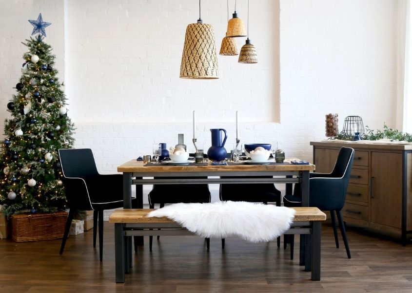 industrial dining table with wooden dining bench and Christmas tree in background