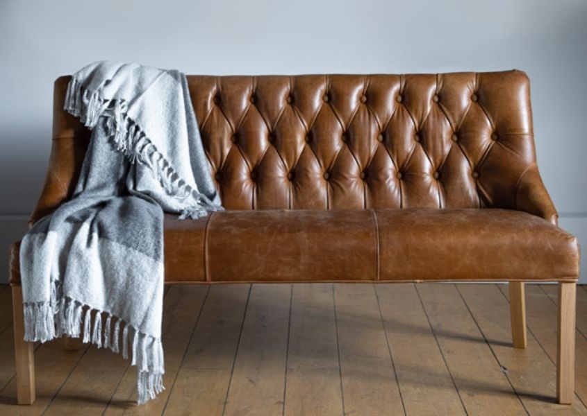 leather bench with back and blue blanket