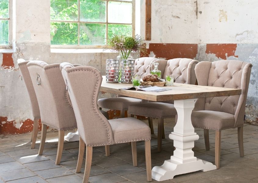 reclaimed wood dining table with white painted monastery leg with fabric dining chairs