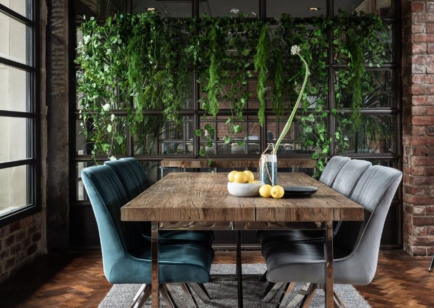 reclaimed wood dining table with hanging green plant screen