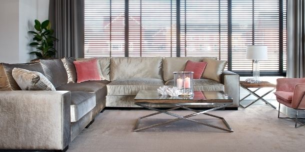 living room with industrial coffee table and two silver fabric sofas