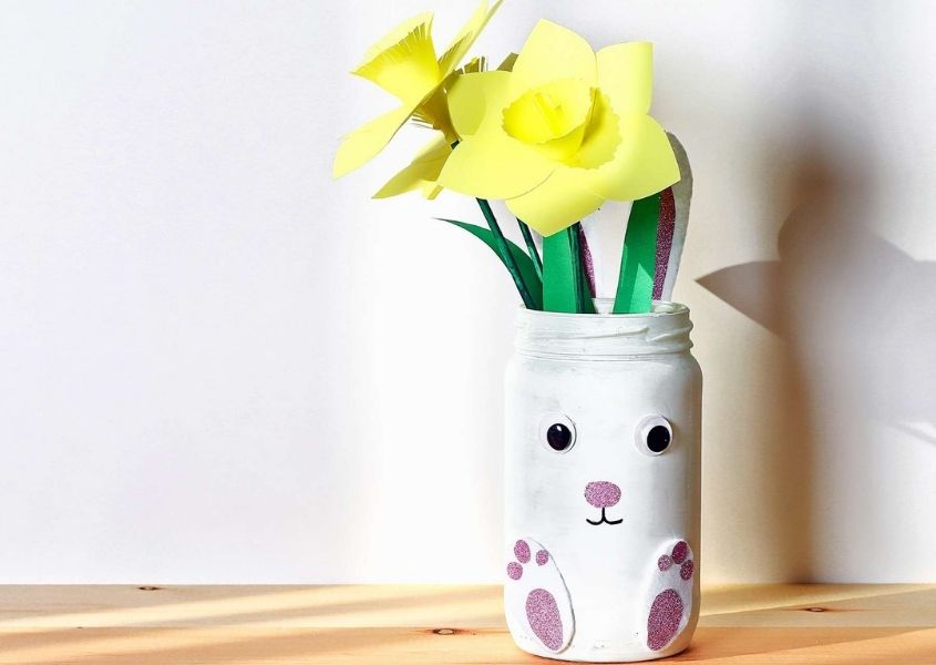 Paper daffodils in a white bunny rabbit vase