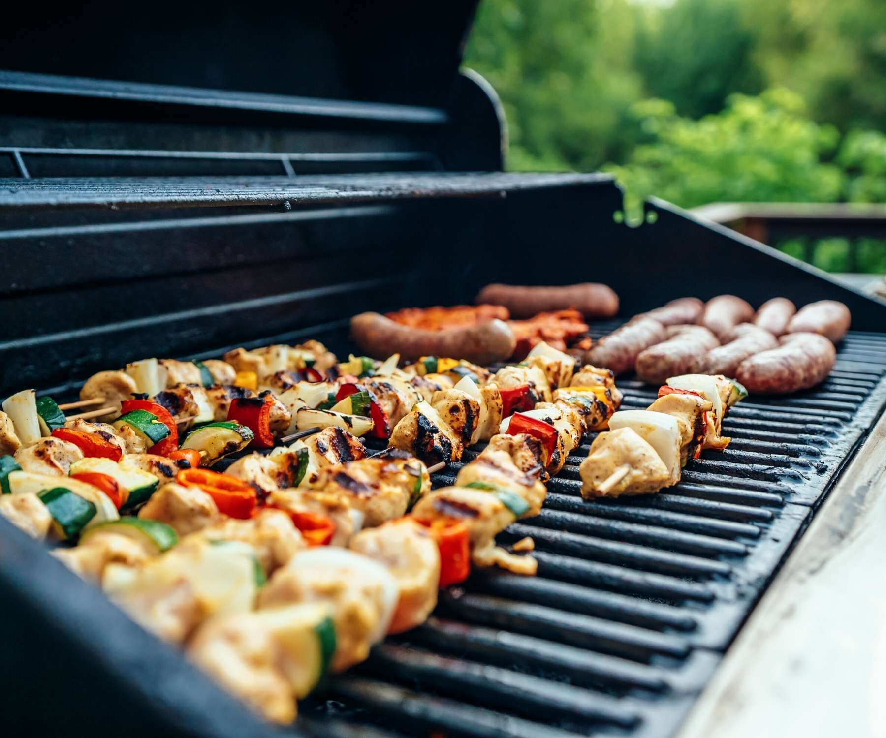 gas barbecue with food on the griddle