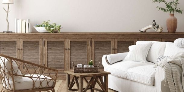 Living room with extra long rustic sideboard with white sofa and wicker armchair