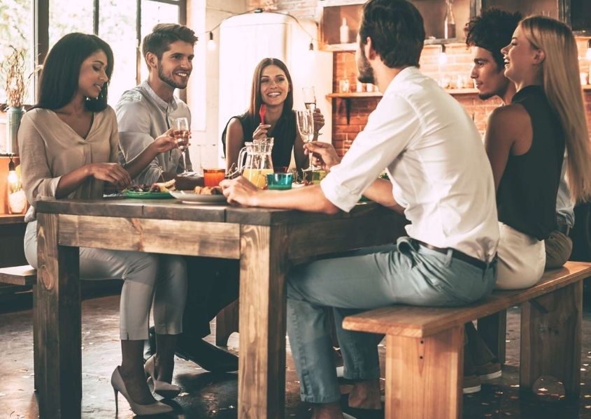 Group of friends around a rustic dining table