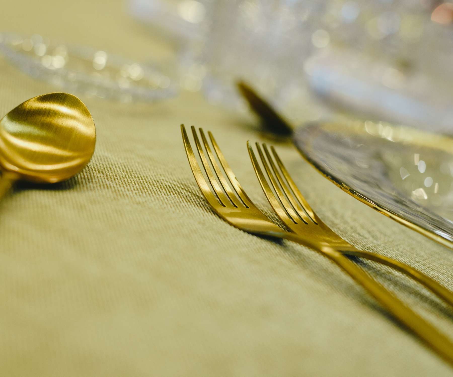 gold cutlery on gold tablecloth
