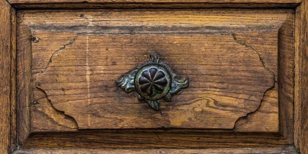 Rustic reclaimed wood drawer with ornate black metal handle