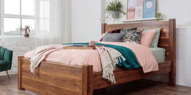 Reclaimed solid wood bed with pink and green covers