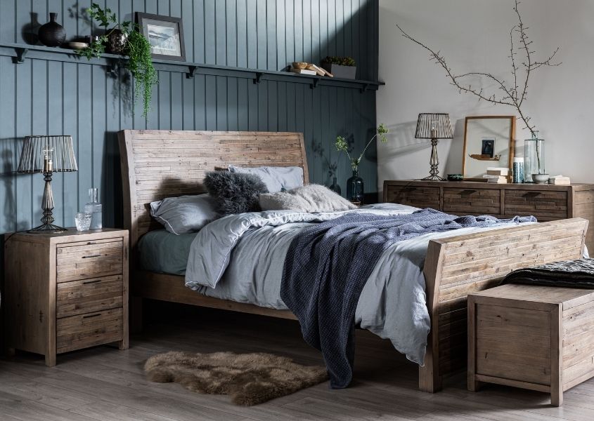 rustic bed with matching rustic bedside table and wooden blanket box