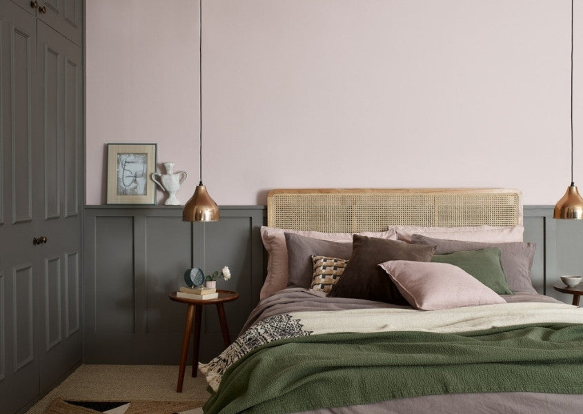 king size bed frame against pink wall and dark grey painted wardrobes