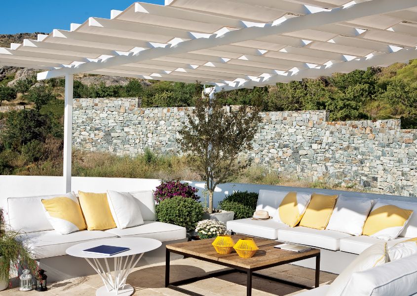 outdoor seating area with white painted wooden pergola