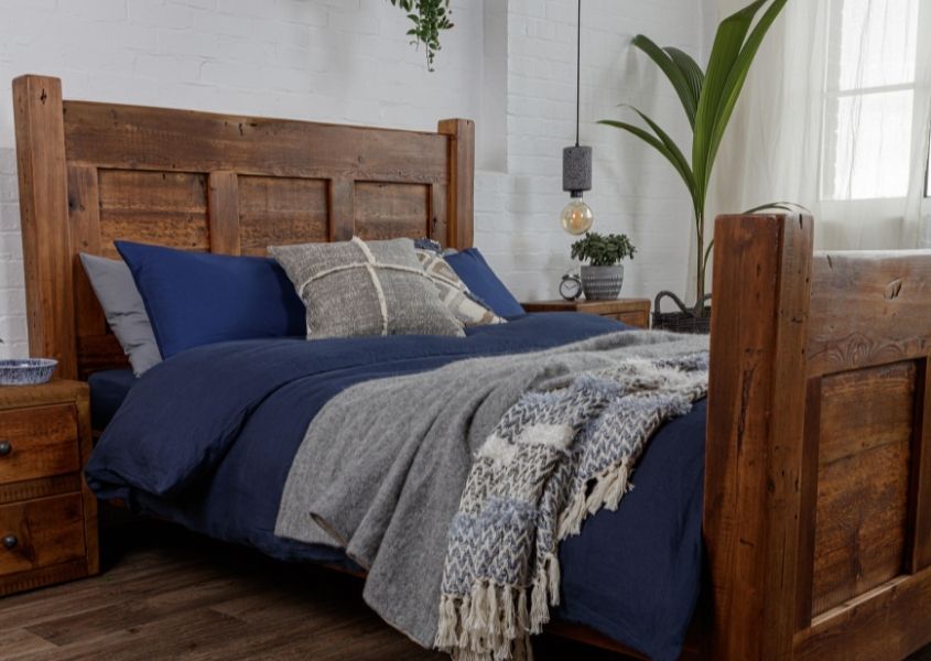 solid wood bed in reclaimed wood with blue covers
