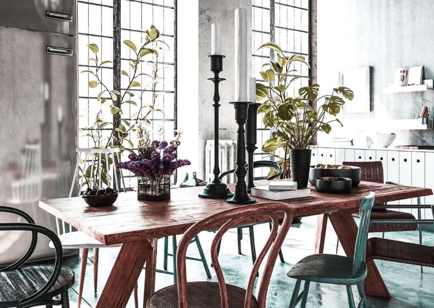wooden dining table with vases of flowers and candlesticks