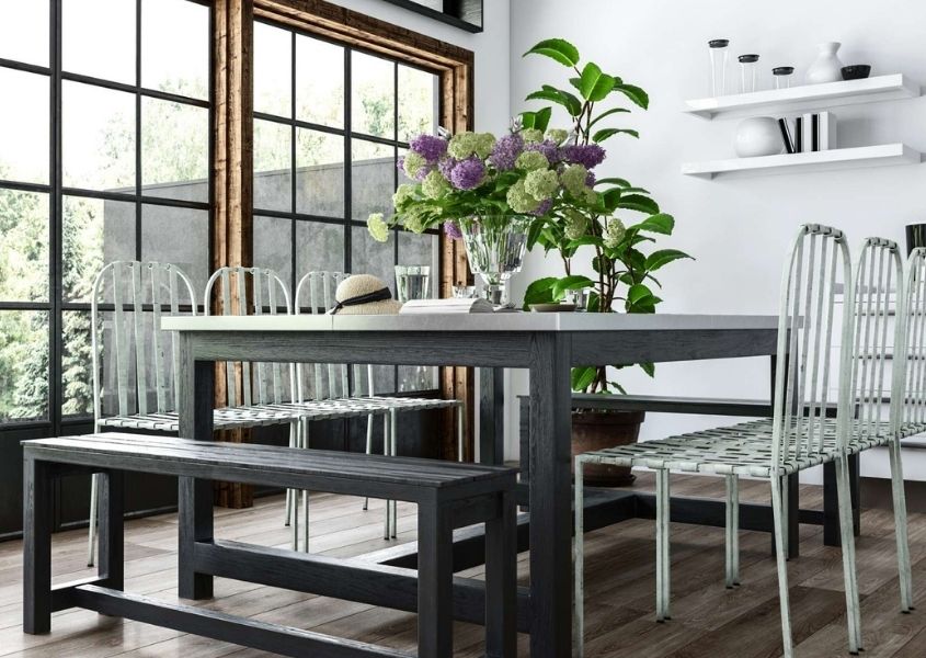 grey wooden dining table with large display of flowers