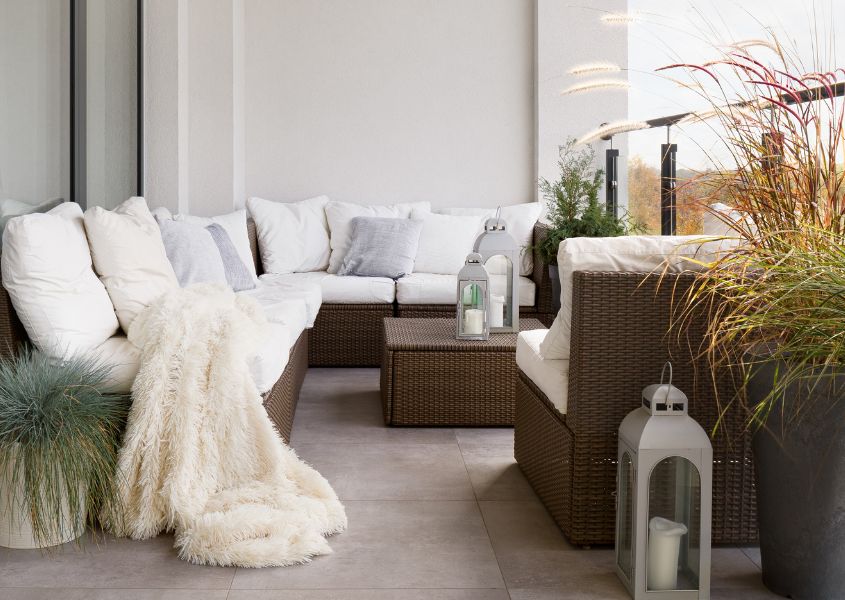 outdoor corner sofa set with white cushions on balcony