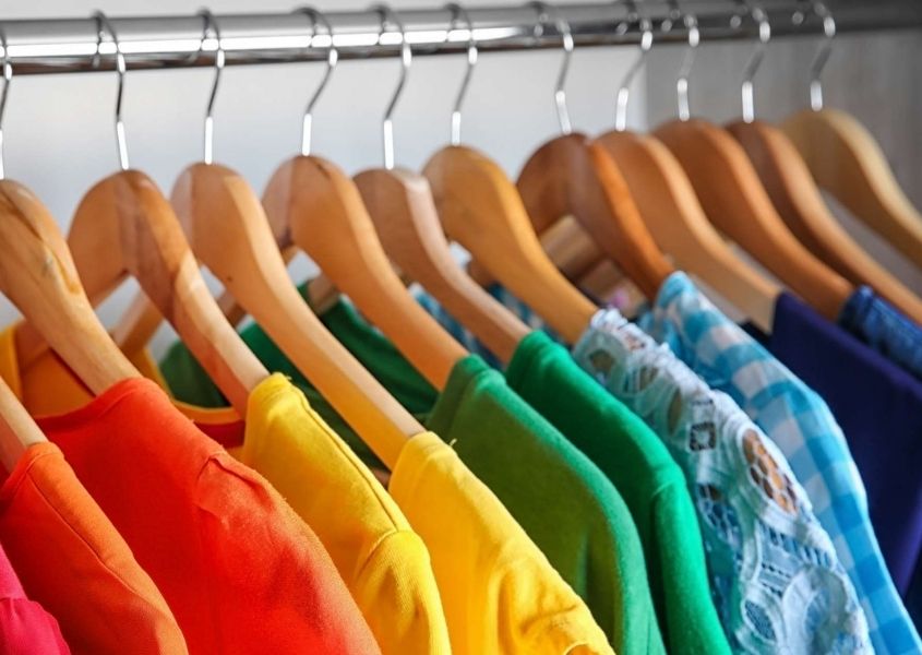 bright coloured clothes on hangers
