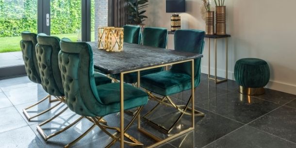Reclaimed wood dining table with dark wood and gold legs with blue velvet dining chairs