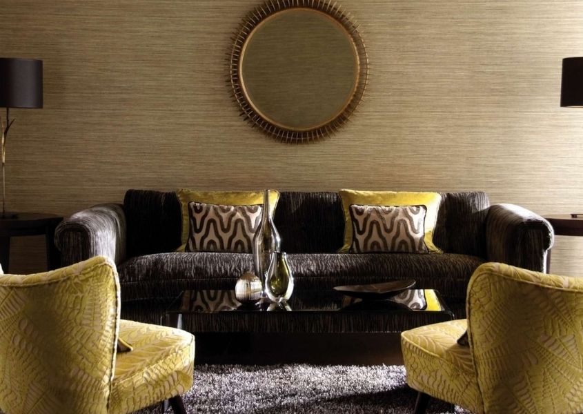 gold fabric armchairs with dark brown sofa and gold round wall mirror