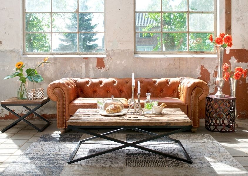 tan leather chesterfield sofa with industrial coffee table