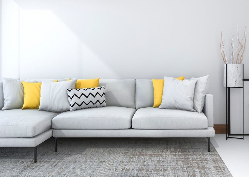 grey modern sofa with yellow cushions
