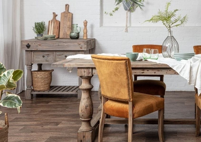 reclaimed wood dining table with orange velvet dining chairs and rustic wood butchers block