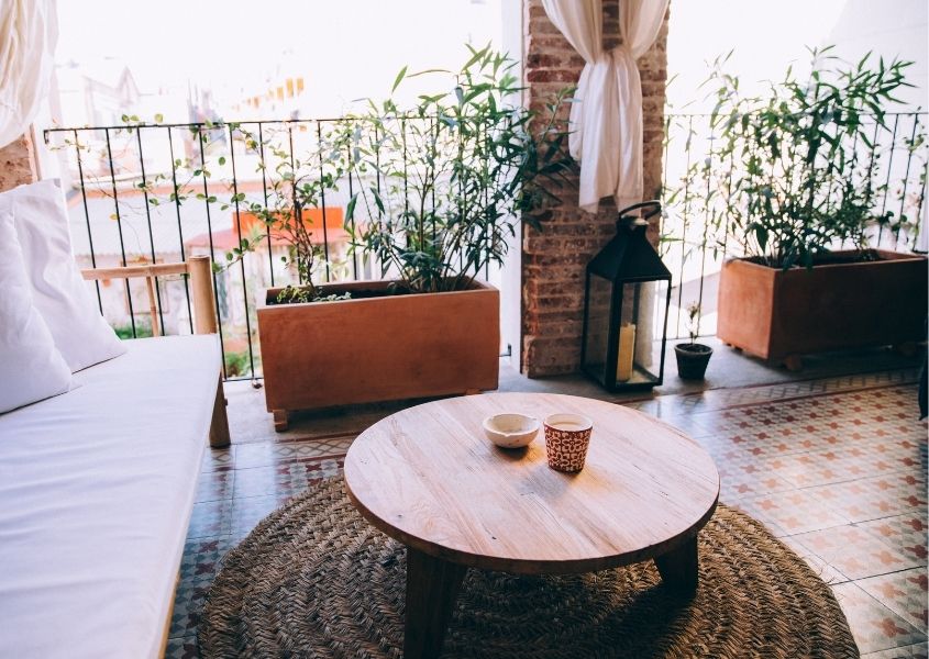 Wooden round coffee table on outdoor balcony
