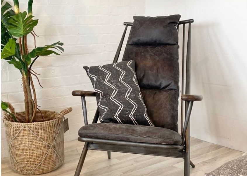 grey leather armchair with green house plant