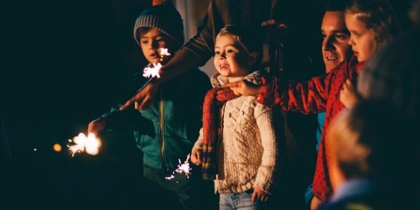 Young children in dark holding sparklers