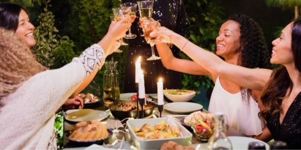 Women raising their glasses for How to host the perfect dinner party blog