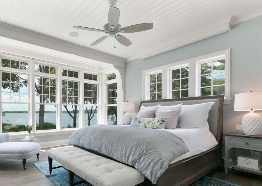 Wooden bed frame with white ceiling fan