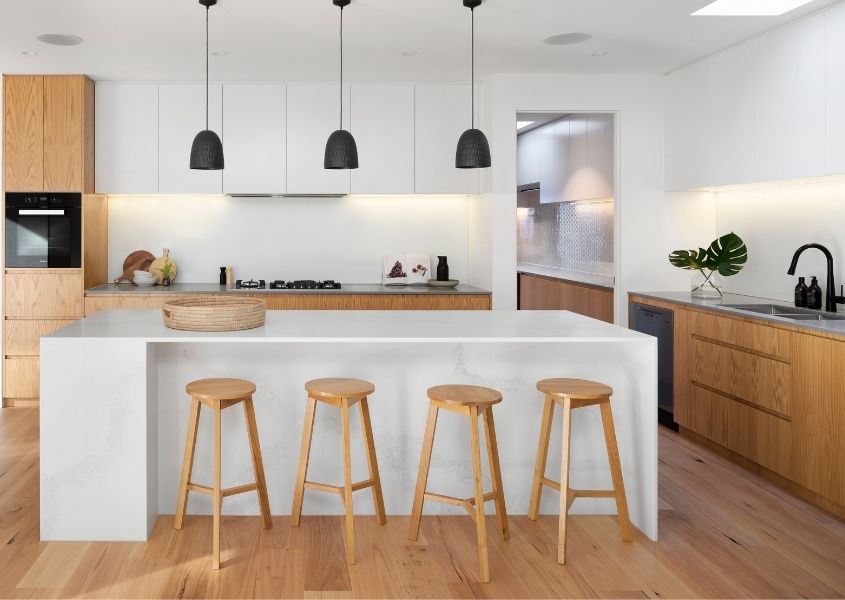 modern white kitchen with wooden bar stools