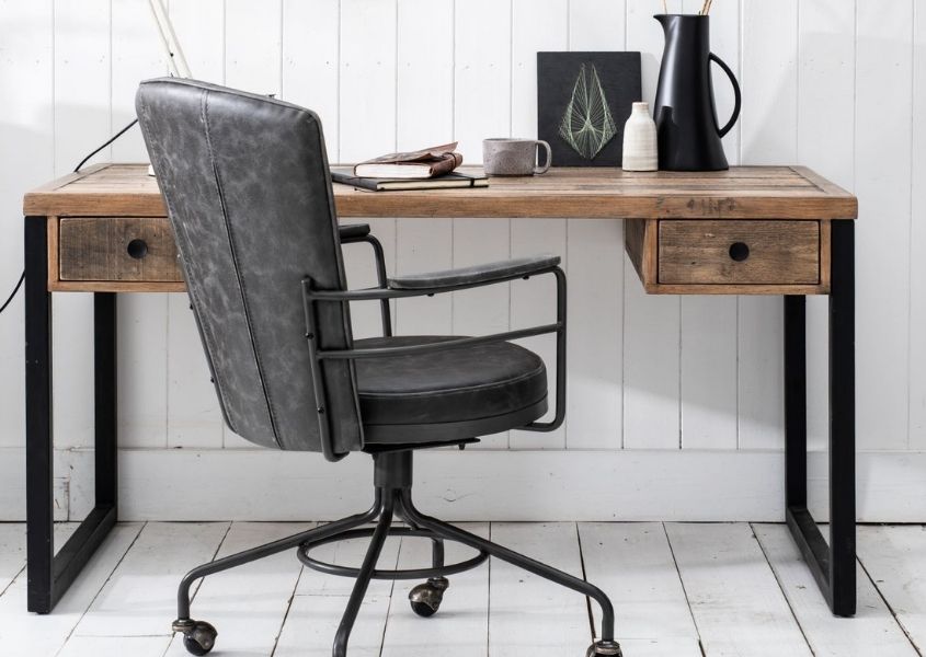 grey faux leather office chair next to industrial desk with black metal legs