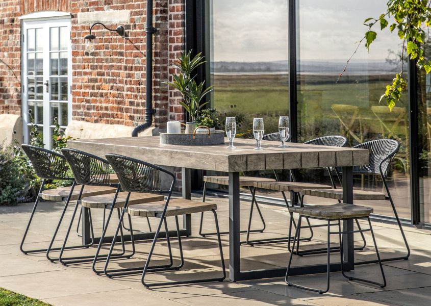 industrial outdoor dining table with matching wooden dining chairs