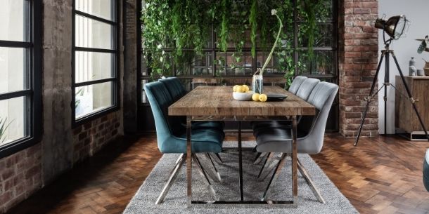 Industrial dining room with reclaimed wood dining table and six velvet dining chairs