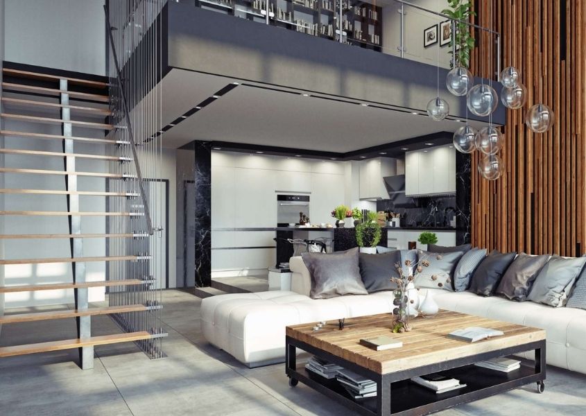 Industrial loft style living room with large grey metal staircase and industrial coffee table