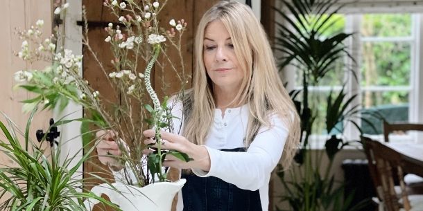 Woman arranging flowers for make your home beautiful with flowers