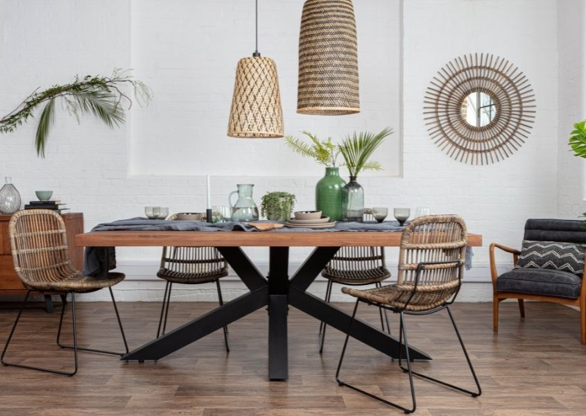 industrial dining table with black metal spider legs and rattan hanging pendant lights