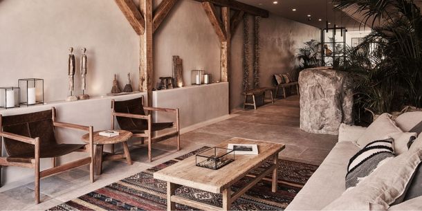 rustic coffee table and leather armchairs at hotel Habitat