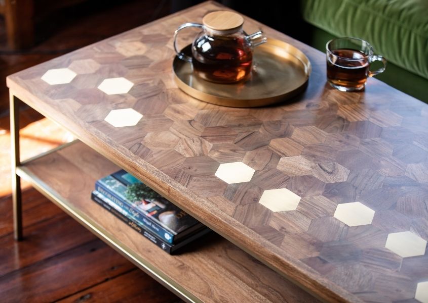 mango wood coffee table with brass inlays and bottom shelf